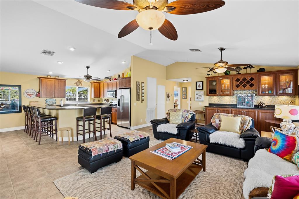 8550 Little Gasparilla Placida, FL 33946 - Photo 22 of 62 a living room with furniture kitchen view and a chandelier