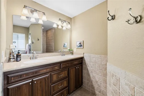 a bathroom with a granite countertop sink mirror vanity and toilet