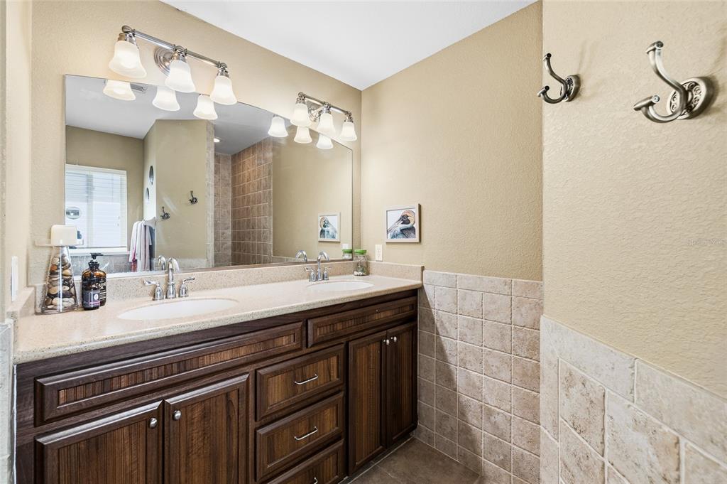 8550 Little Gasparilla Placida, FL 33946 - Photo 28 of 62 a spacious bathroom with a granite countertop sink a large mirror and a shower