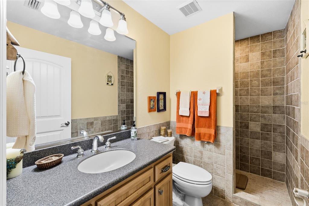 8550 Little Gasparilla Placida, FL 33946 - Photo 33 of 62 a bathroom with a granite countertop sink mirror vanity and toilet