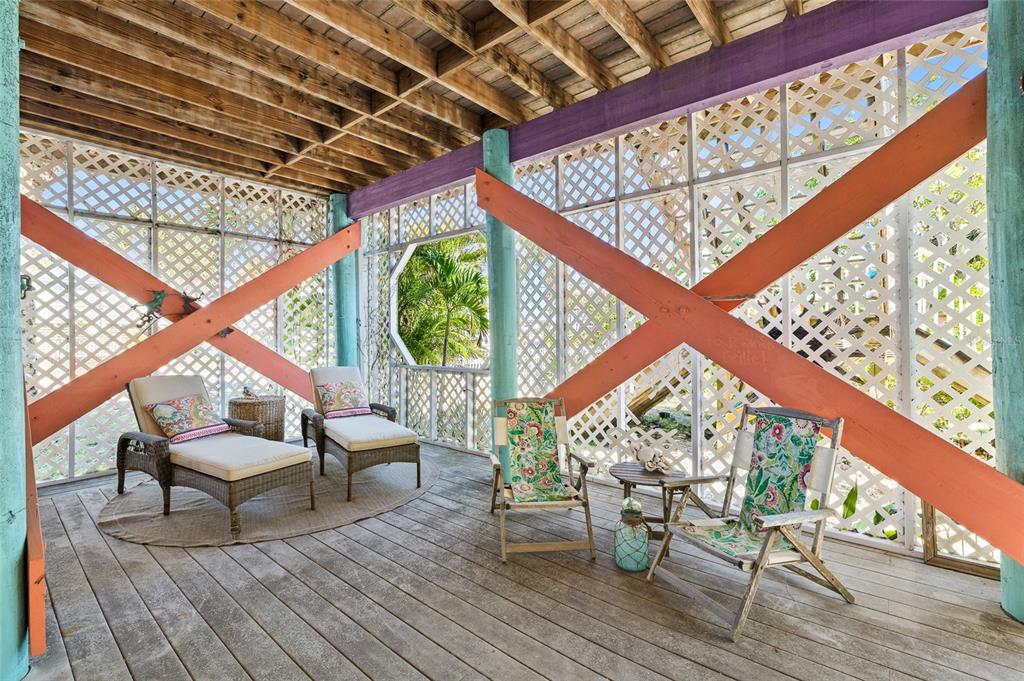 8550 Little Gasparilla Placida, FL 33946 - Photo 44 of 62 a balcony with wooden floor and outdoor seating
