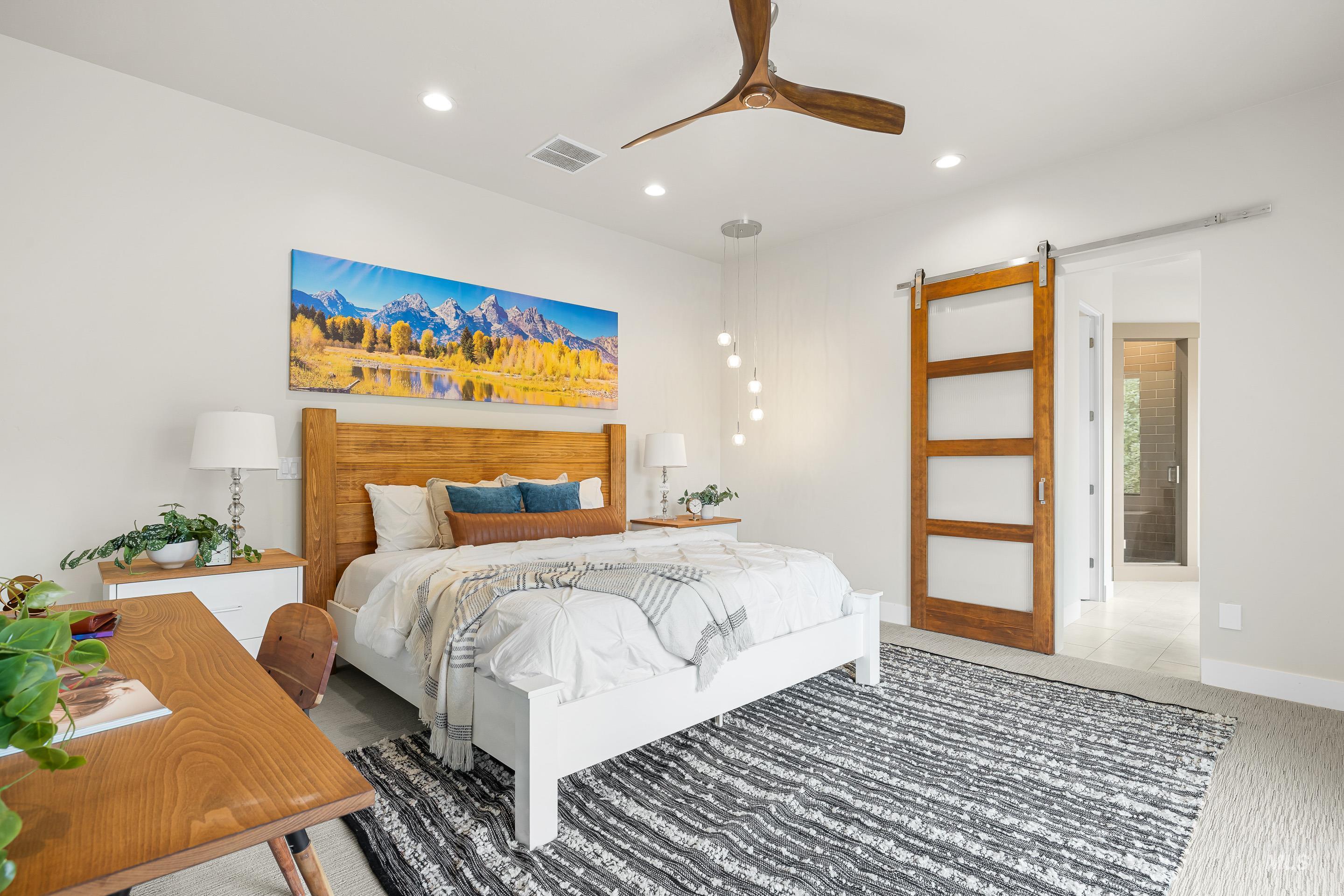 3672 West Red Jade Court Meridian, ID 83646 - Photo 18 of 50 Bedroom featuring recessed lighting, ceiling fan, a barn door, and connected bathroom