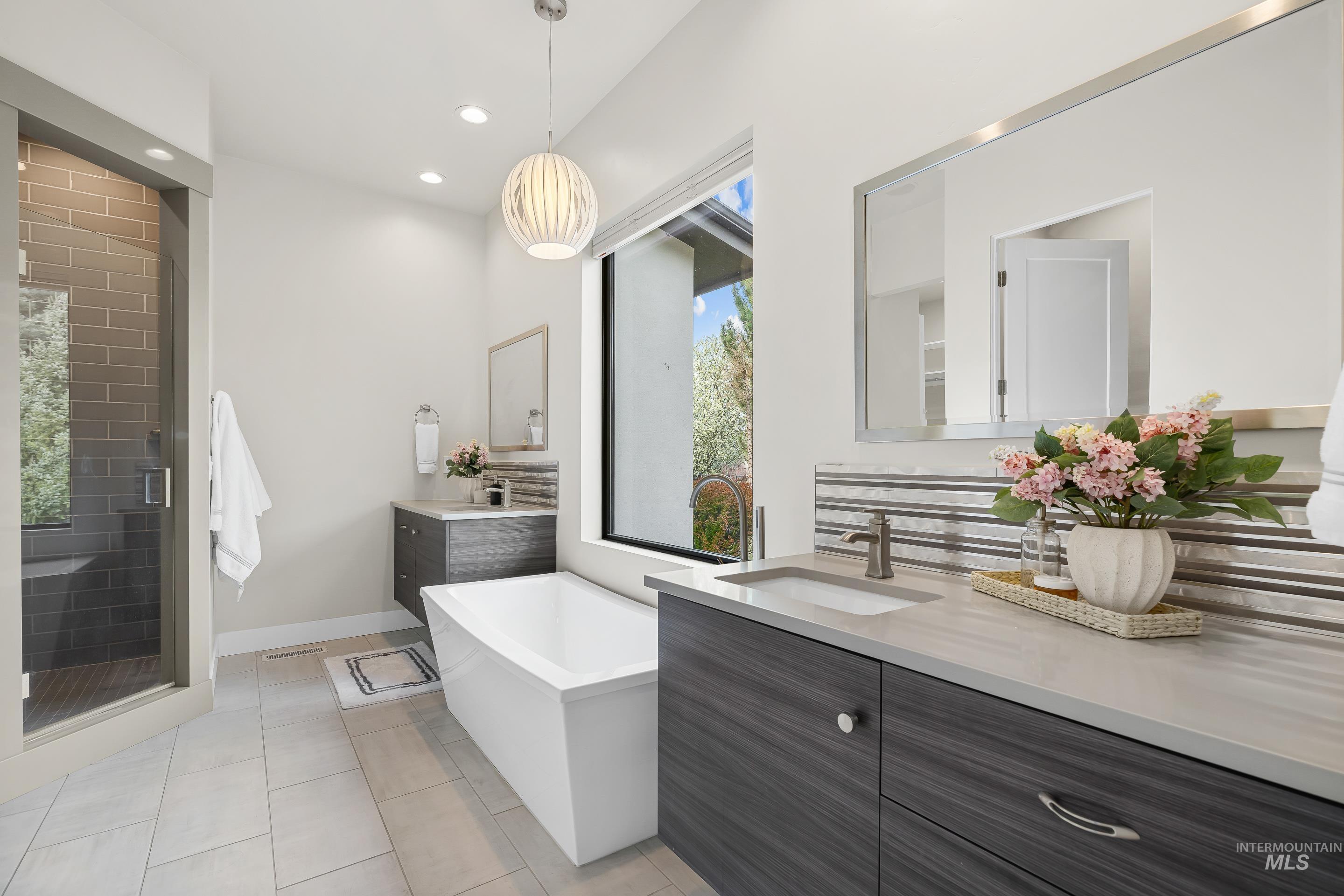 3672 West Red Jade Court Meridian, ID 83646 - Photo 22 of 50 Bathroom featuring a soaking tub, two vanities, a shower stall, light tile patterned floors, and recessed lighting