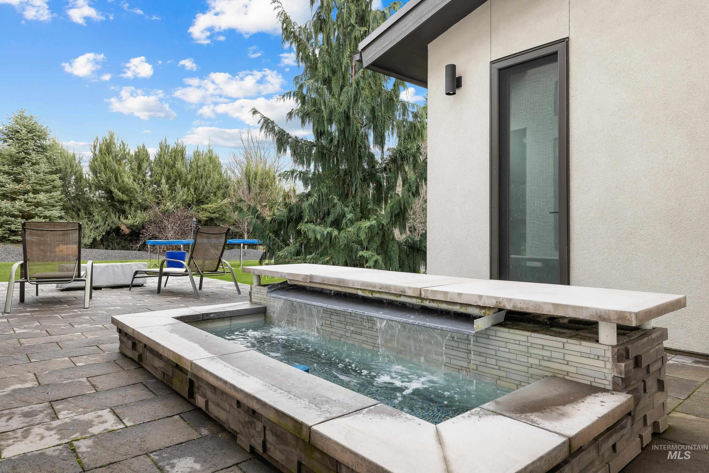 3672 West Red Jade Court Meridian, ID 83646 - Photo 33 of 50 View of pool with patio surround and an in-ground hot tub