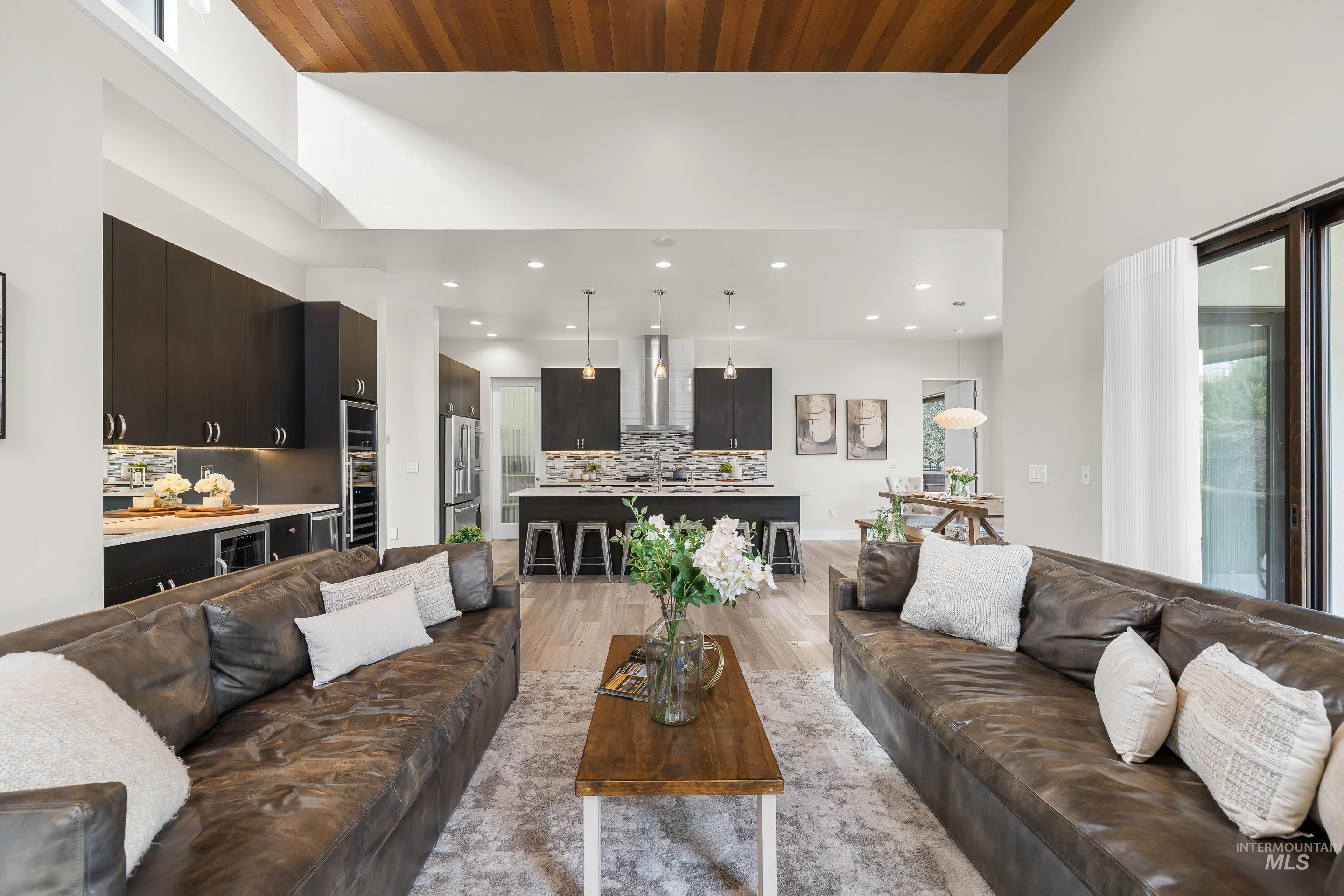 3672 West Red Jade Court Meridian, ID 83646 - Photo 6 of 50 Living area with light wood-type flooring, a high wooden ceiling, beverage cooler, and recessed lighting