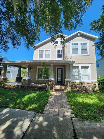 a front view of a house with a yard and porch