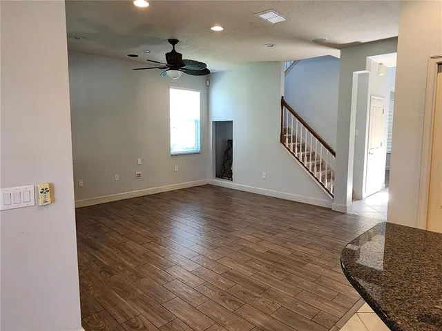 a kitchen with stainless steel appliances granite countertop a refrigerator and a stove top oven