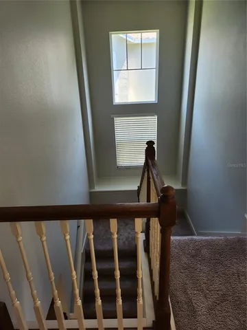 a view of a livingroom with a ceiling fan and window