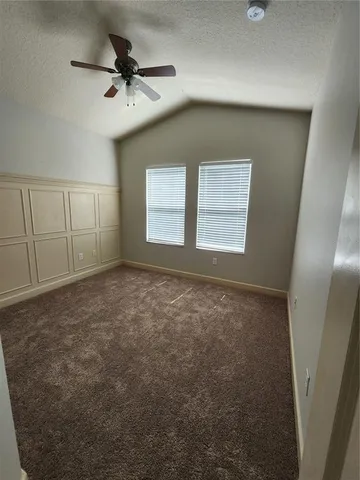 a bathroom with a granite countertop sink mirror vanity and toilet