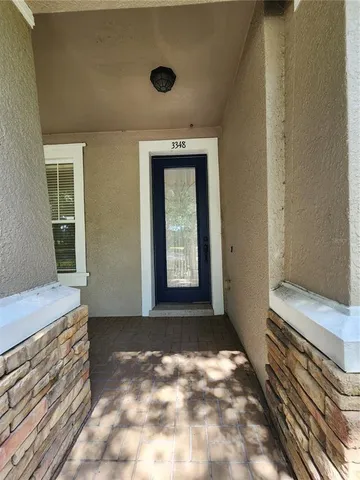 a view of a hallway with wooden floor and a window