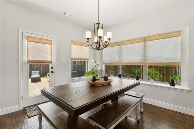 a view of a dining room with furniture wooden floor and chandelier