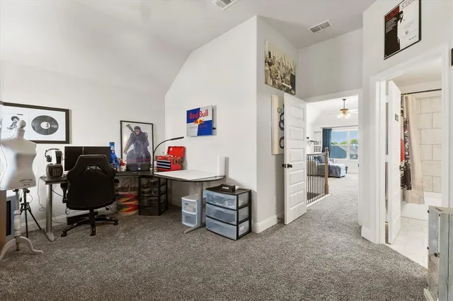 a living room with furniture and a baby crib