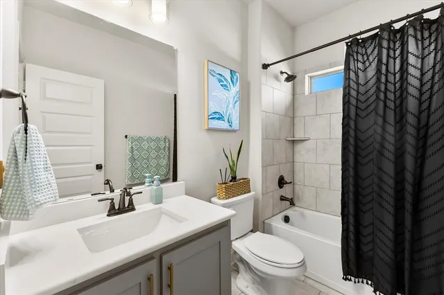 a bathroom with a sink toilet a mirror and shower