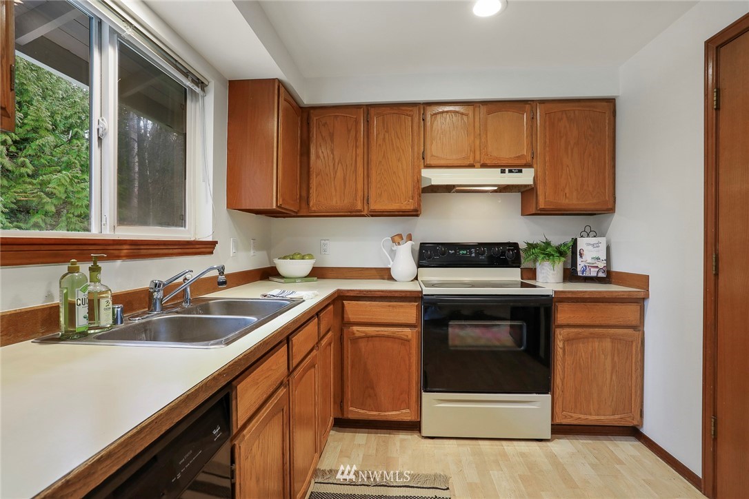 22515 20th Avenue Southeast Bothell, WA 98021 - Photo 12 of 34 a kitchen with a sink and a stove top oven