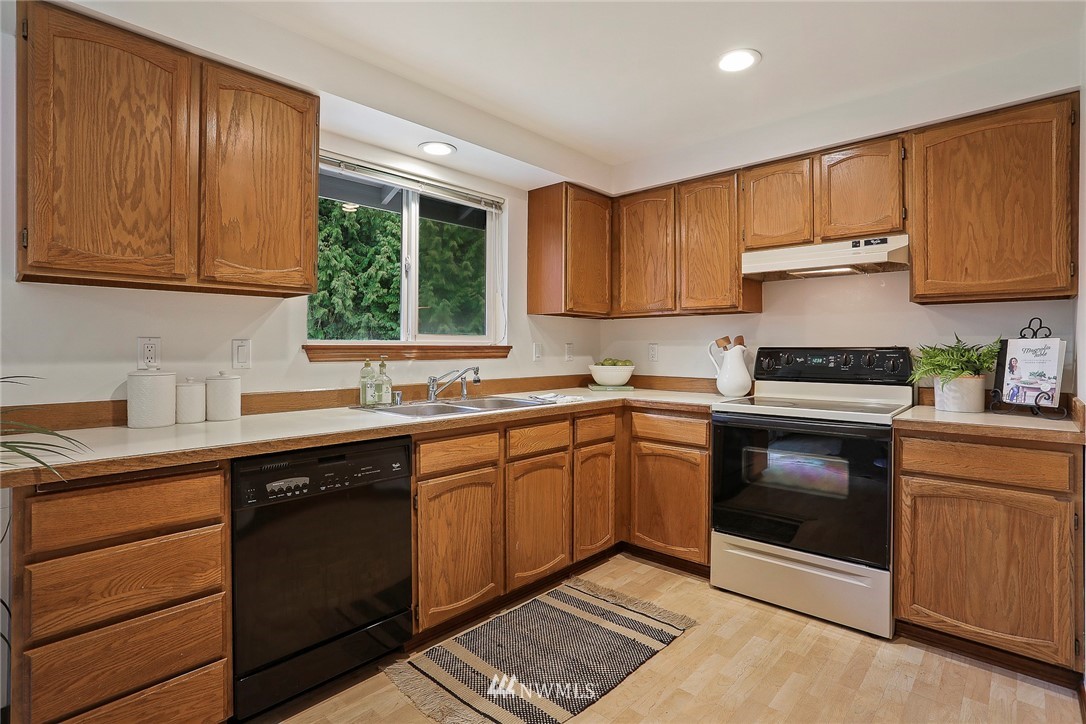 22515 20th Avenue Southeast Bothell, WA 98021 - Photo 13 of 34 a kitchen with a sink stove and cabinets