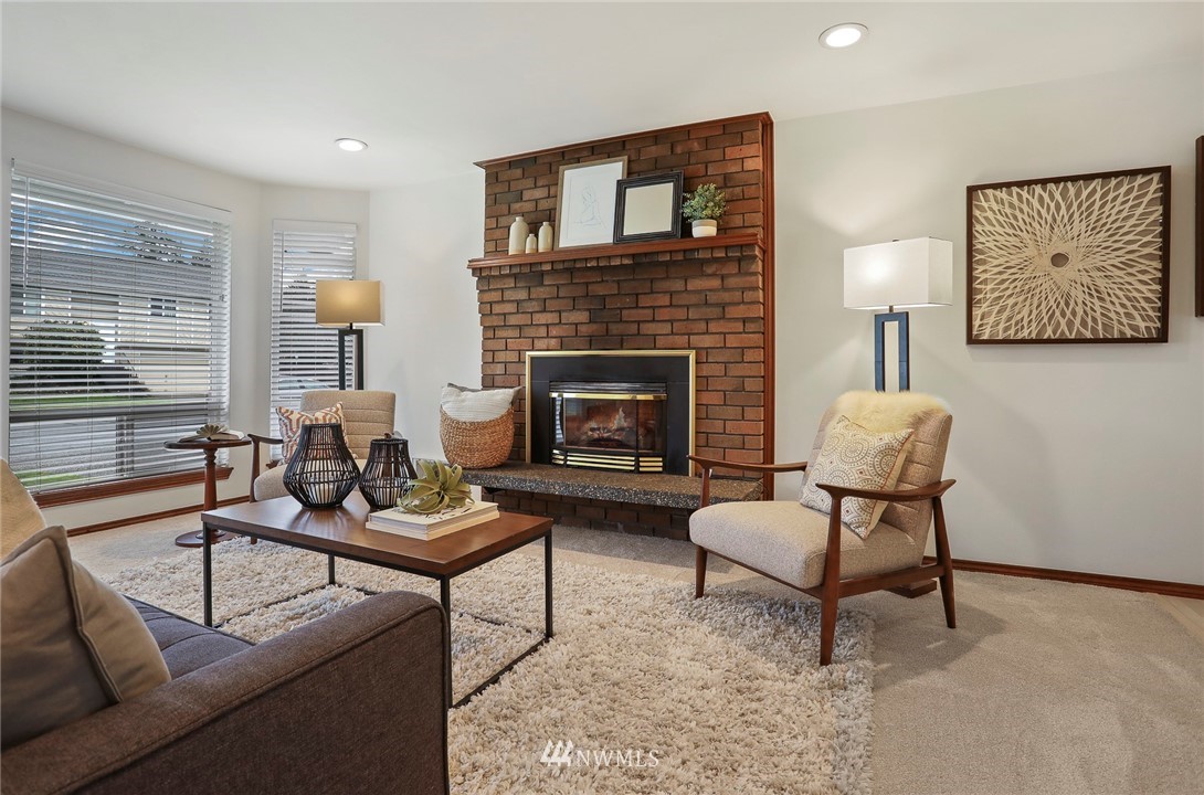 22515 20th Avenue Southeast Bothell, WA 98021 - Photo 3 of 34 a living room with furniture and a fireplace