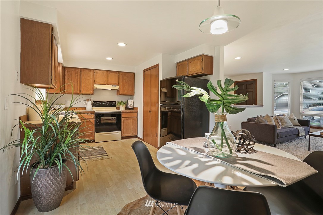 22515 20th Avenue Southeast Bothell, WA 98021 - Photo 8 of 34 a dining room with furniture a potted plant and kitchen view