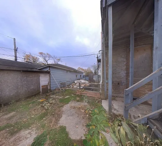 a view of hallway with wooden floor and cabinet