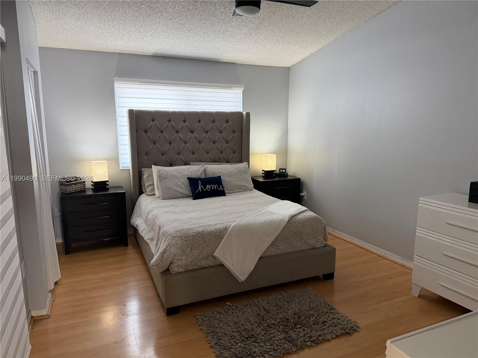 7431 Southwest 163rd Place Miami, FL 33193 - Photo 15 of 18 a bedroom with a bed and wooden floor