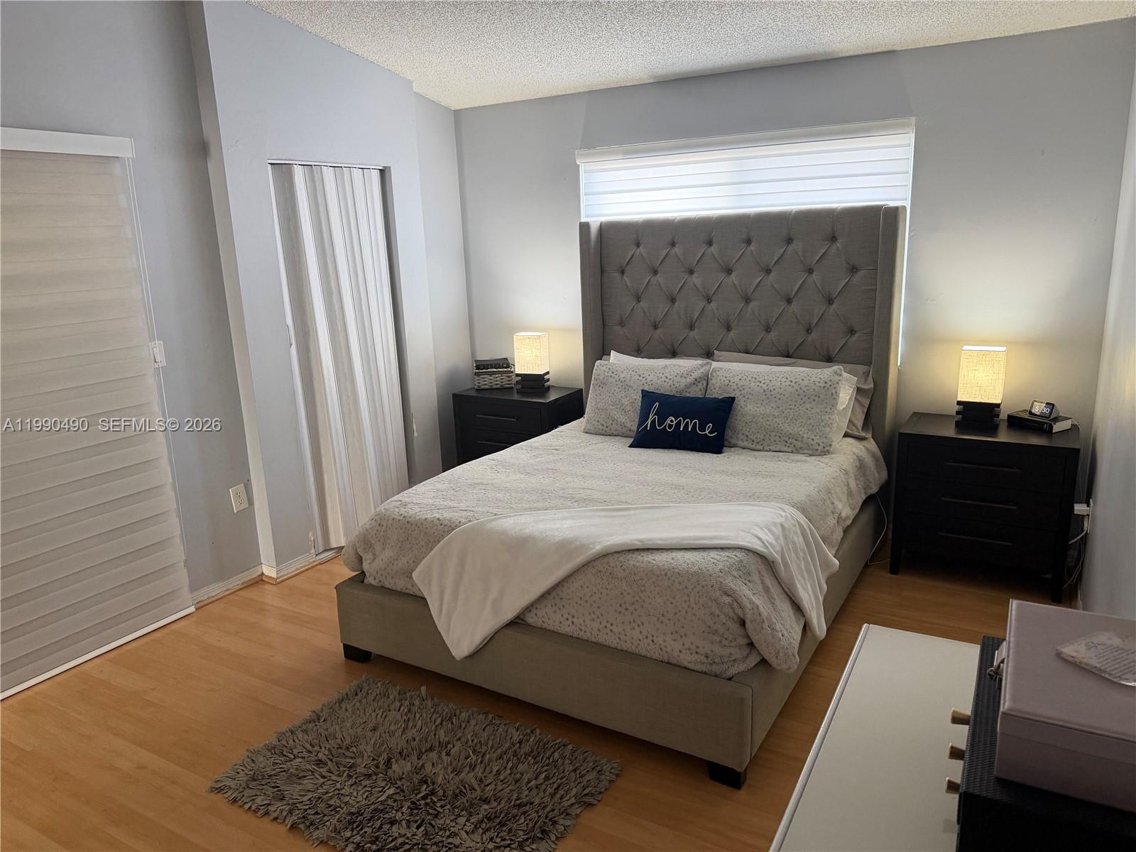 7431 Southwest 163rd Place Miami, FL 33193 - Photo 16 of 18 a bedroom with a bed and a night stand