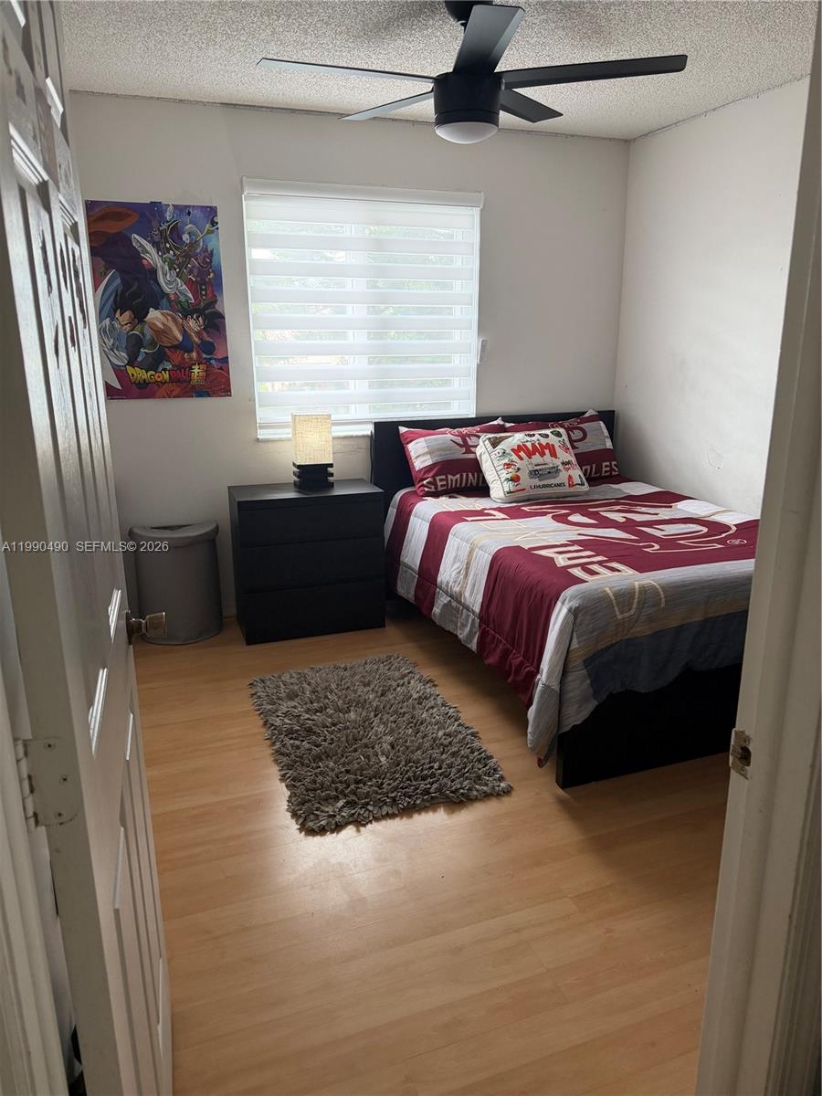 7431 Southwest 163rd Place Miami, FL 33193 - Photo 17 of 18 a bedroom with a bed and a painting on the wall