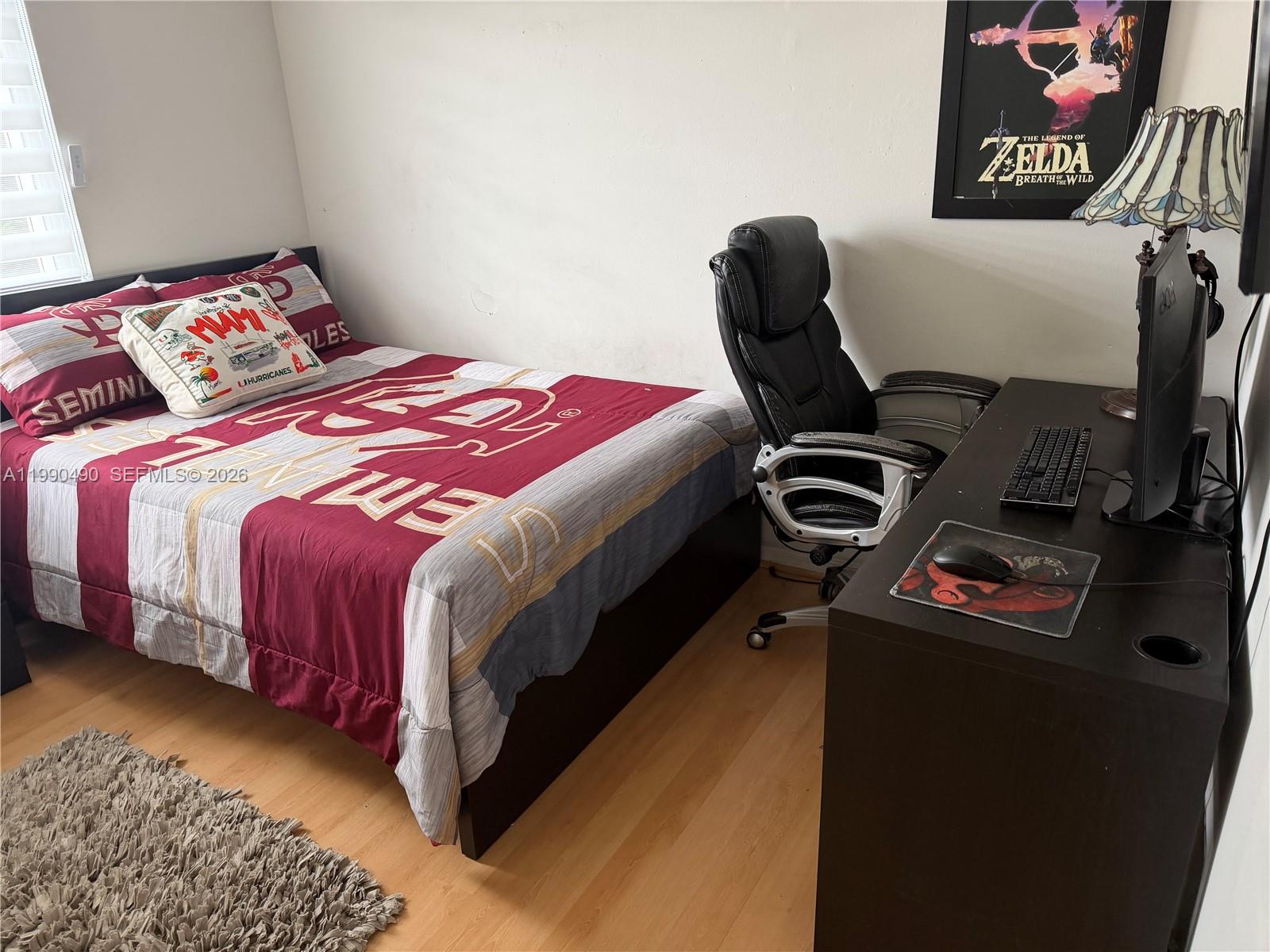 7431 Southwest 163rd Place Miami, FL 33193 - Photo 18 of 18 a bedroom with a bed and a chair