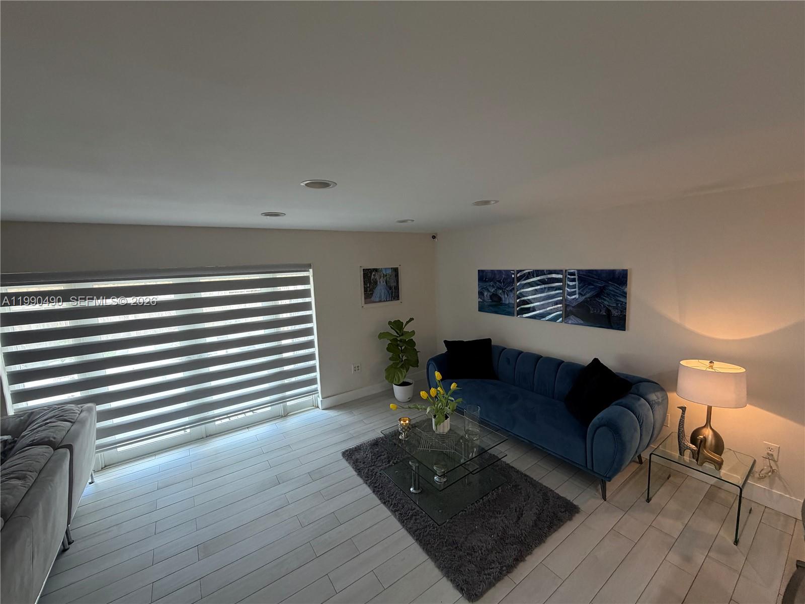 7431 Southwest 163rd Place Miami, FL 33193 - Photo 6 of 18 a living room with furniture and wooden floor