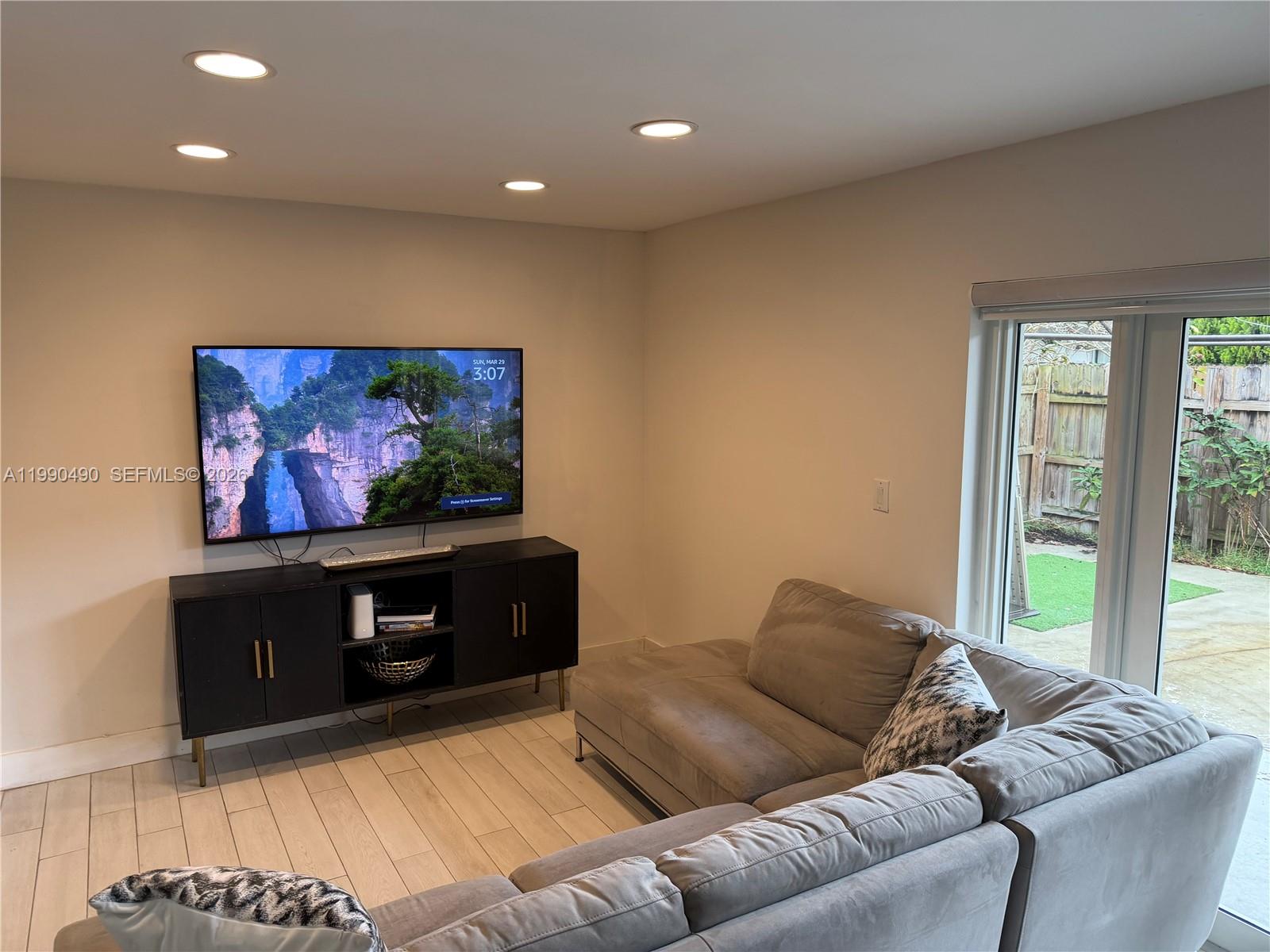 7431 Southwest 163rd Place Miami, FL 33193 - Photo 8 of 18 a living room with furniture and a flat screen tv