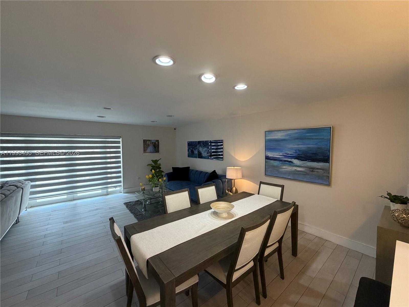 7431 Southwest 163rd Place Miami, FL 33193 - Photo 9 of 18 a view of a dining room with furniture and wooden floor
