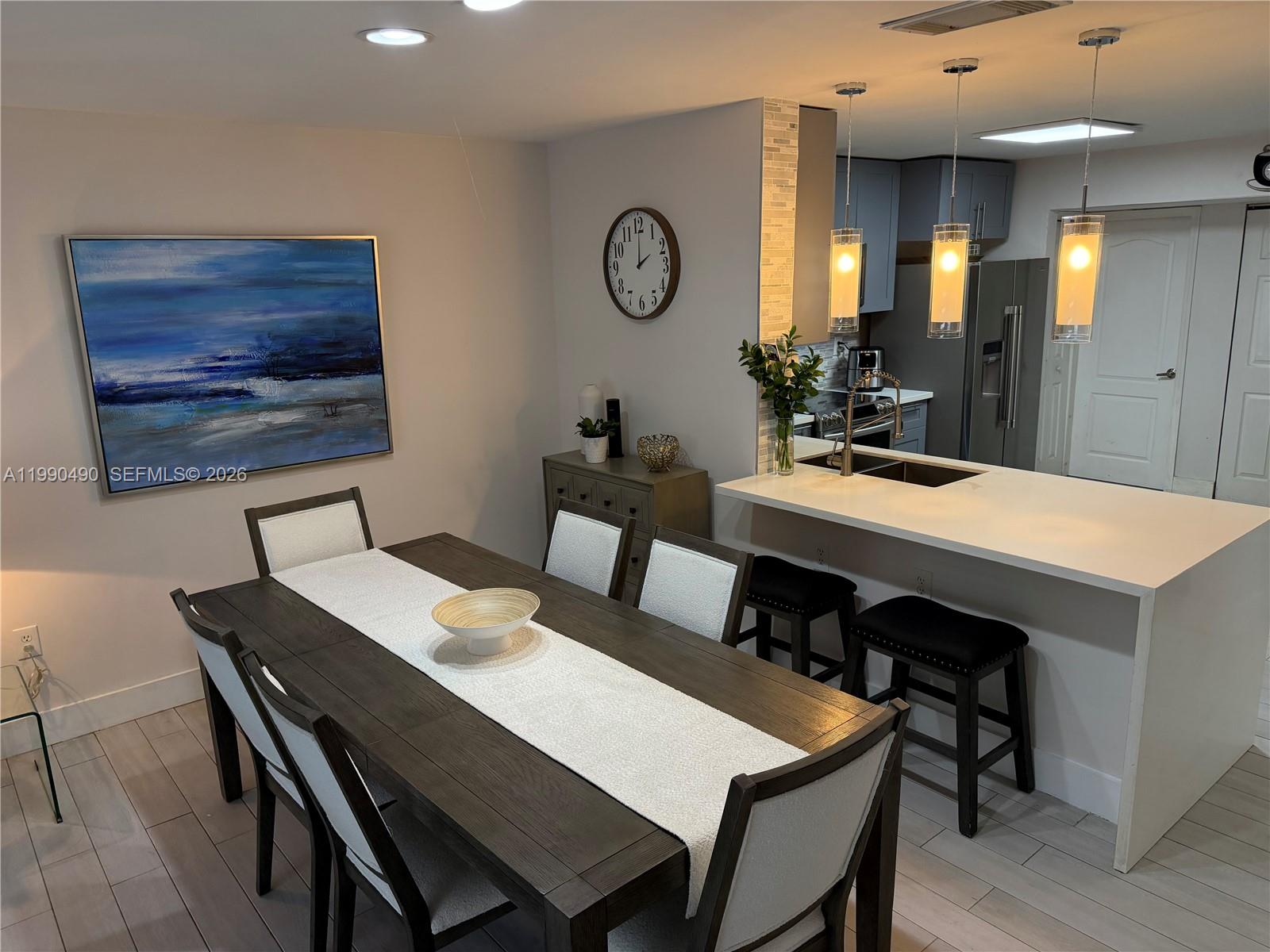 7431 Southwest 163rd Place Miami, FL 33193 - Photo 10 of 18 a view of a dining room with furniture and wooden floor