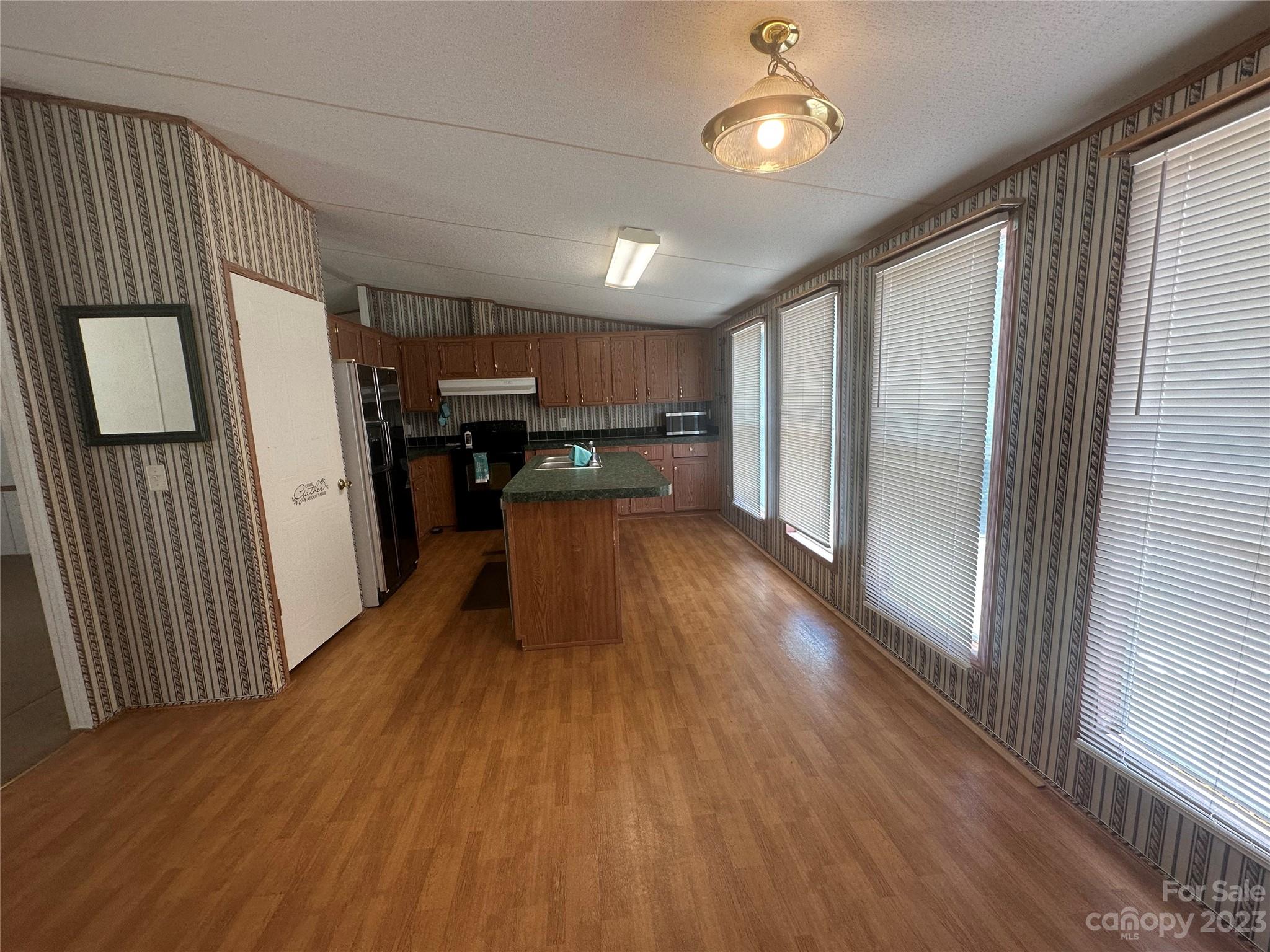 2780 Camp Creek Road Lancaster, SC 29720 - Photo 18 of 33 a view of a kitchen with refrigerator and wooden floor