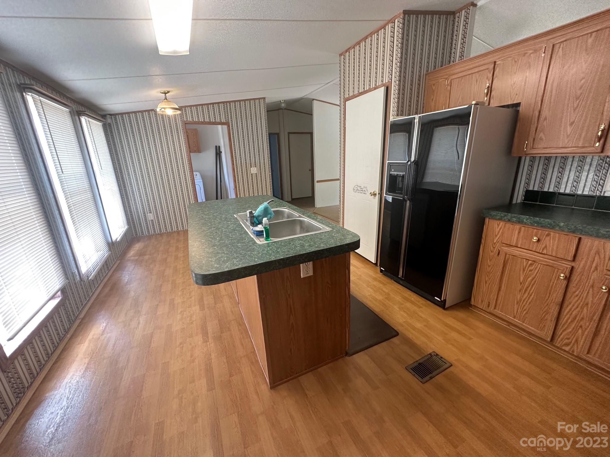 2780 Camp Creek Road Lancaster, SC 29720 - Photo 19 of 33 a kitchen with stainless steel appliances granite countertop a refrigerator a stove and a wooden floors