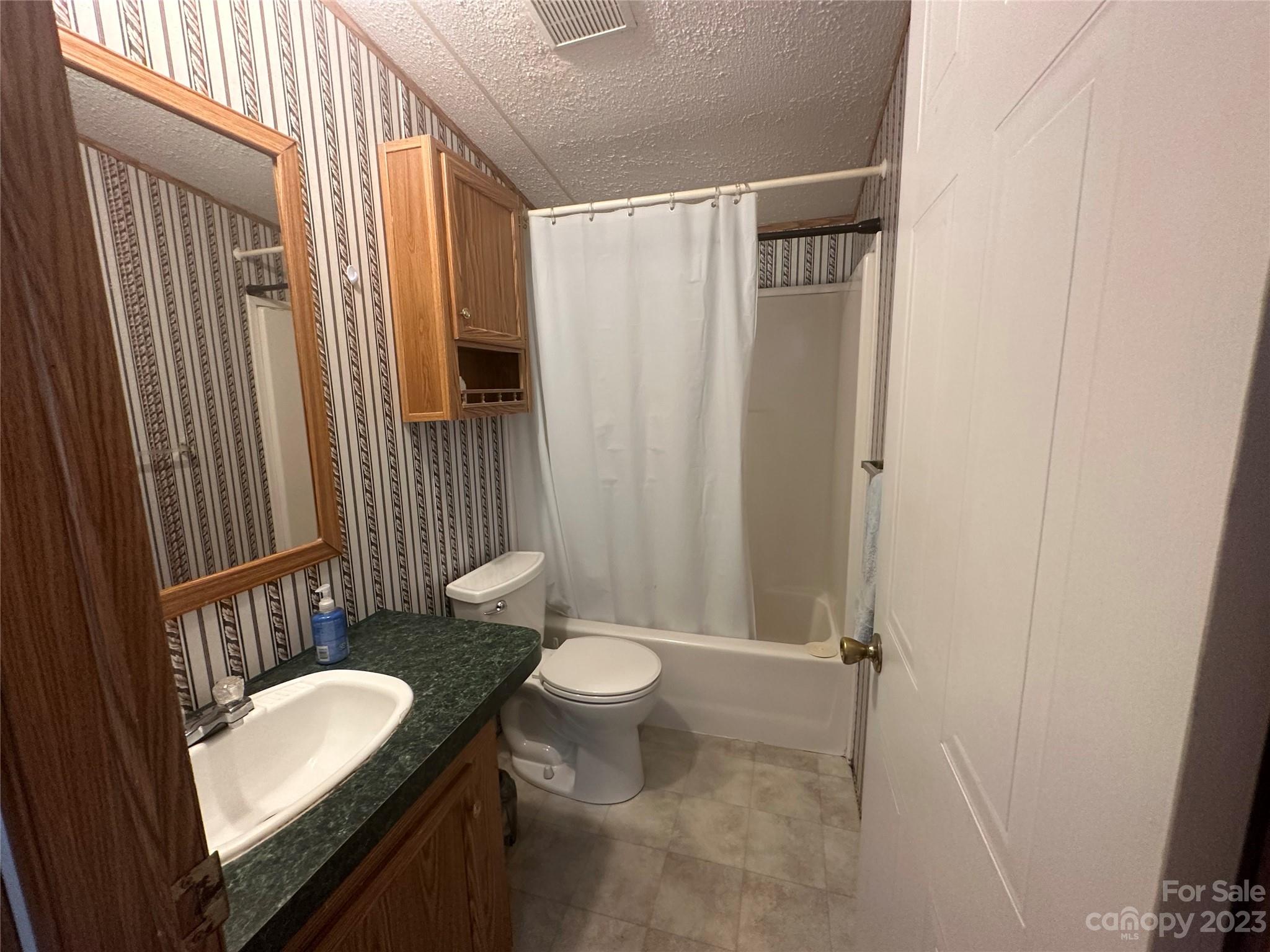 2780 Camp Creek Road Lancaster, SC 29720 - Photo 27 of 33 a bathroom with a granite countertop sink toilet and shower