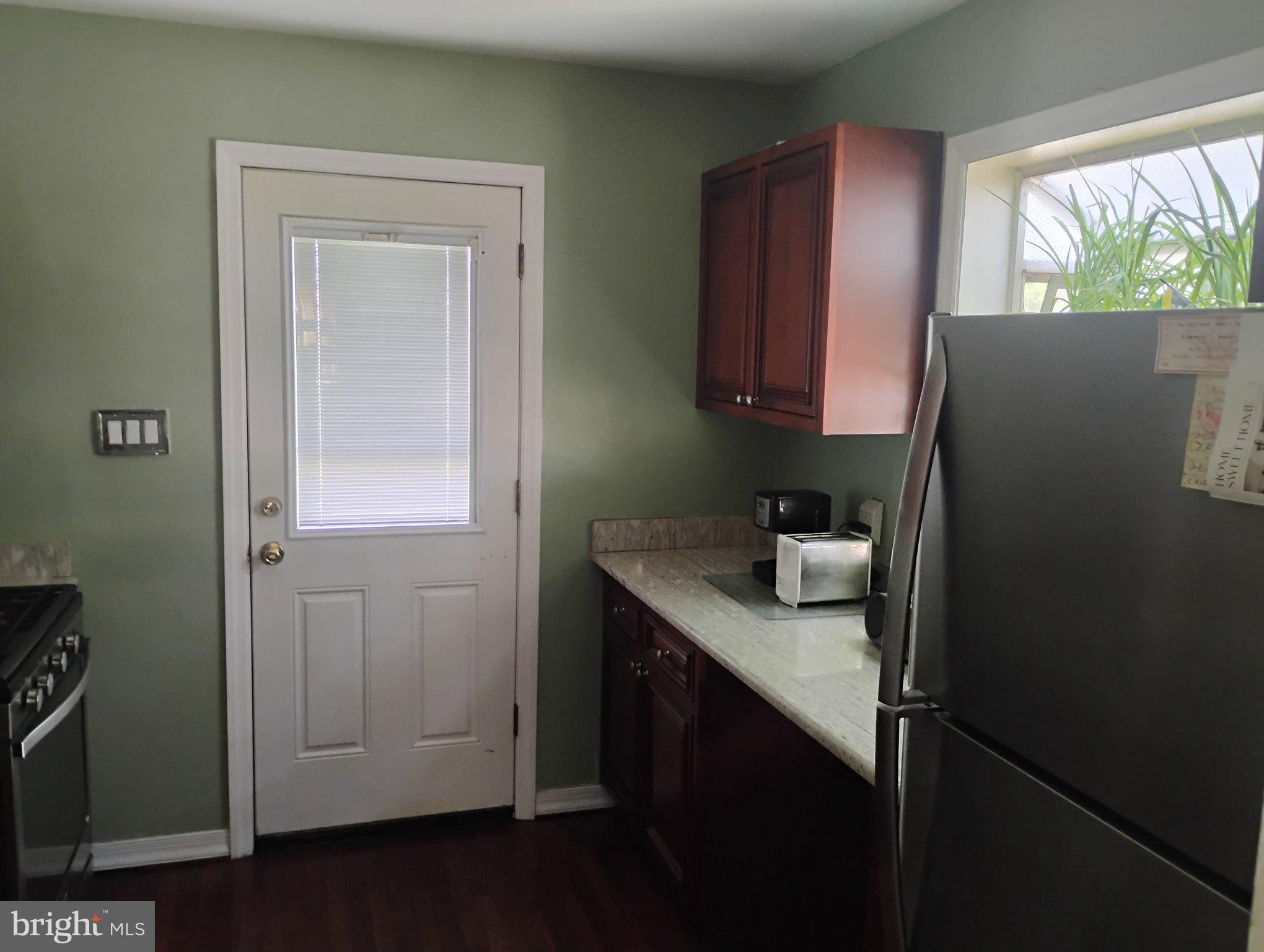 3908 Lantern Drive Silver Spring, MD 20902 - Photo 4 of 15 a kitchen with a refrigerator and cabinets