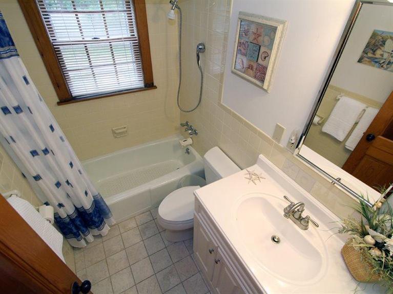 26 Grey Neck Road, Unit 2 West Harwich, MA 02671 - Photo 17 of 19 a bathroom with a sink mirror vanity and toilet