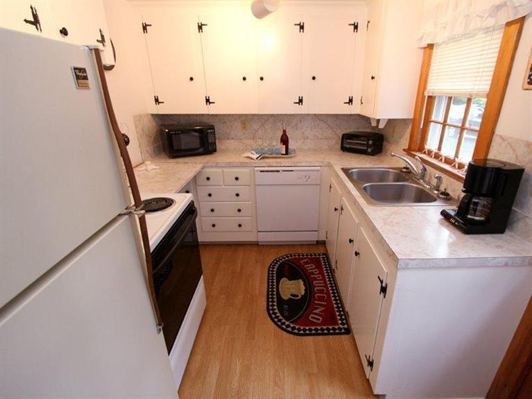 26 Grey Neck Road, Unit 2 West Harwich, MA 02671 - Photo 6 of 19 a kitchen with a sink a stove and cabinets