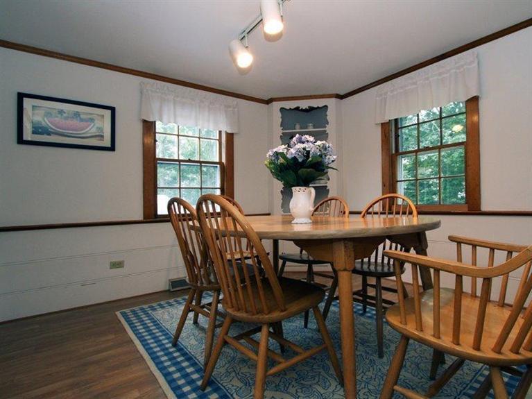 26 Grey Neck Road, Unit 2 West Harwich, MA 02671 - Photo 9 of 19 a view of a dining room with furniture window and wooden floor