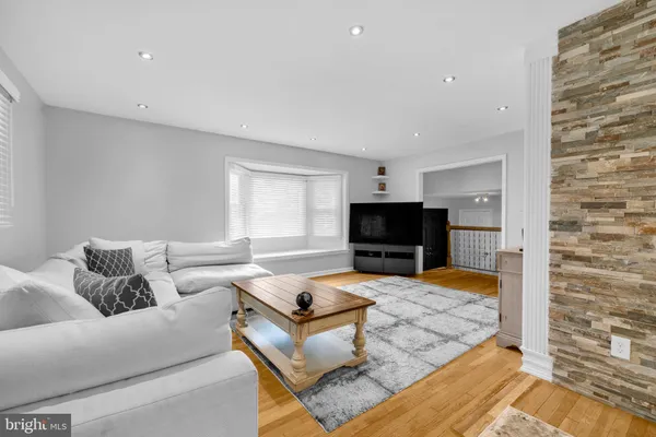 a kitchen with granite countertop a sink dishwasher a dining table and chairs with wooden floor