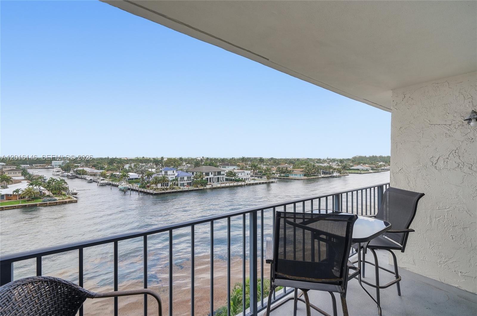 521 North Riverside Drive, Unit 606 Pompano Beach, FL 33062 - Photo 14 of 50 a view of a balcony with wooden chairs