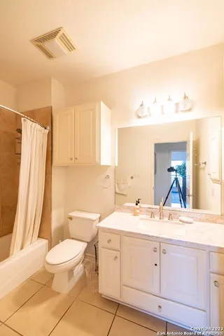 a bathroom with a toilet a sink and a mirror