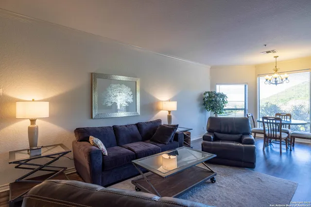 a living room with furniture and a lamp