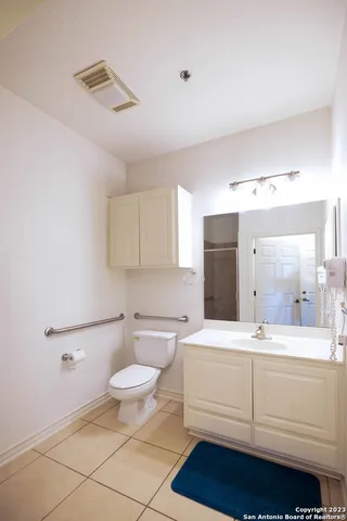 a bathroom with a sink toilet and a mirror