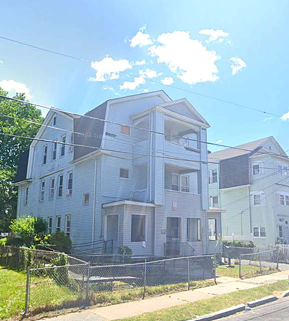 134 Magnolia Street Hartford, CT 06112 - Photo 1 of 1 a view of a tall building with a water fall and potted plants