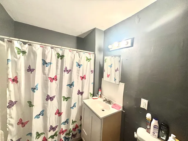 a bathroom with a sink toilet and shower