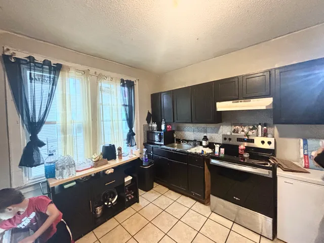 a kitchen with a sink stove and cabinets