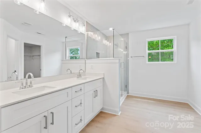 a bathroom with a double vanity sink and a mirror