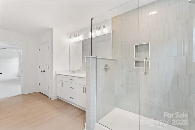 a bathroom with a shower and a sink
