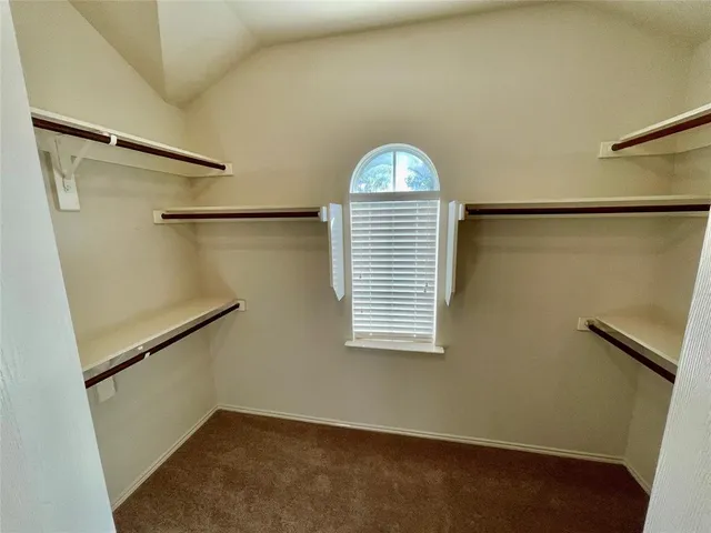 a spacious bathroom with a double vanity sink a large mirror and a shower