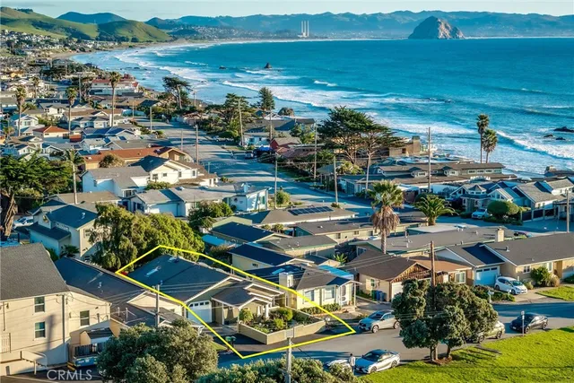 an aerial view of a houses with a swimming pool