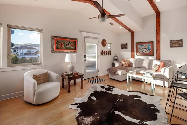 a living room with furniture chess board and a window